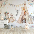 Forest animals wallpaper in bright nursery with white furniture showing enchanted deer and butterflies