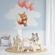 Flying Fox nursery wallpaper in a cozy reading nook with rocking chair and soft lighting