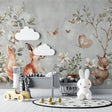 Forest animals wallpaper creating magic in a bright nursery with white furniture and natural decor