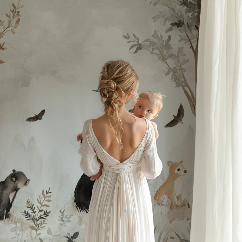Forest animal wallpaper bringing nature into baby room with neutral decor and warm lighting