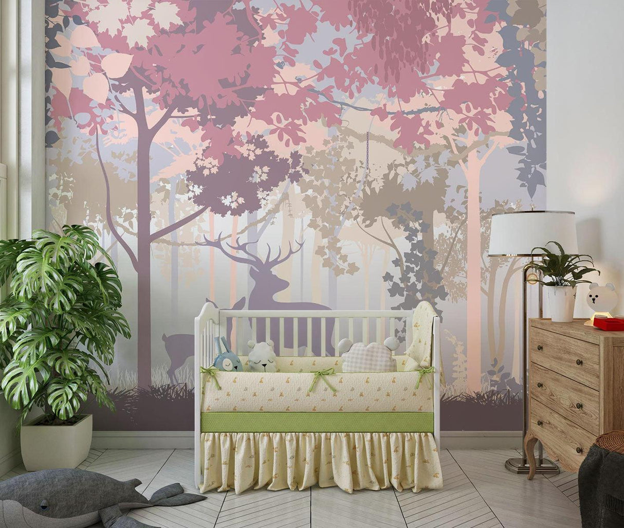 Baby room with deer silhouette wallpaper in gentle pink and purple tones
