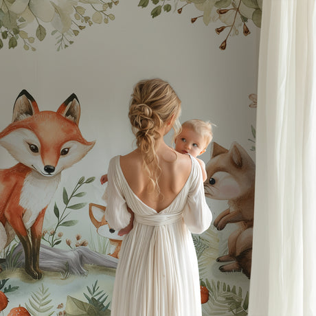Forest animals wallpaper creating a cozy atmosphere in a modern nursery with white furniture