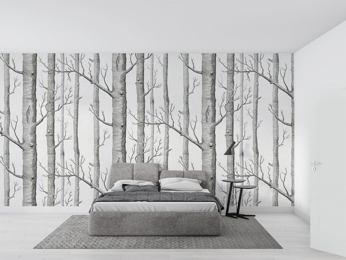 Black and white forest wallpaper creating depth in modern living room with minimal furniture