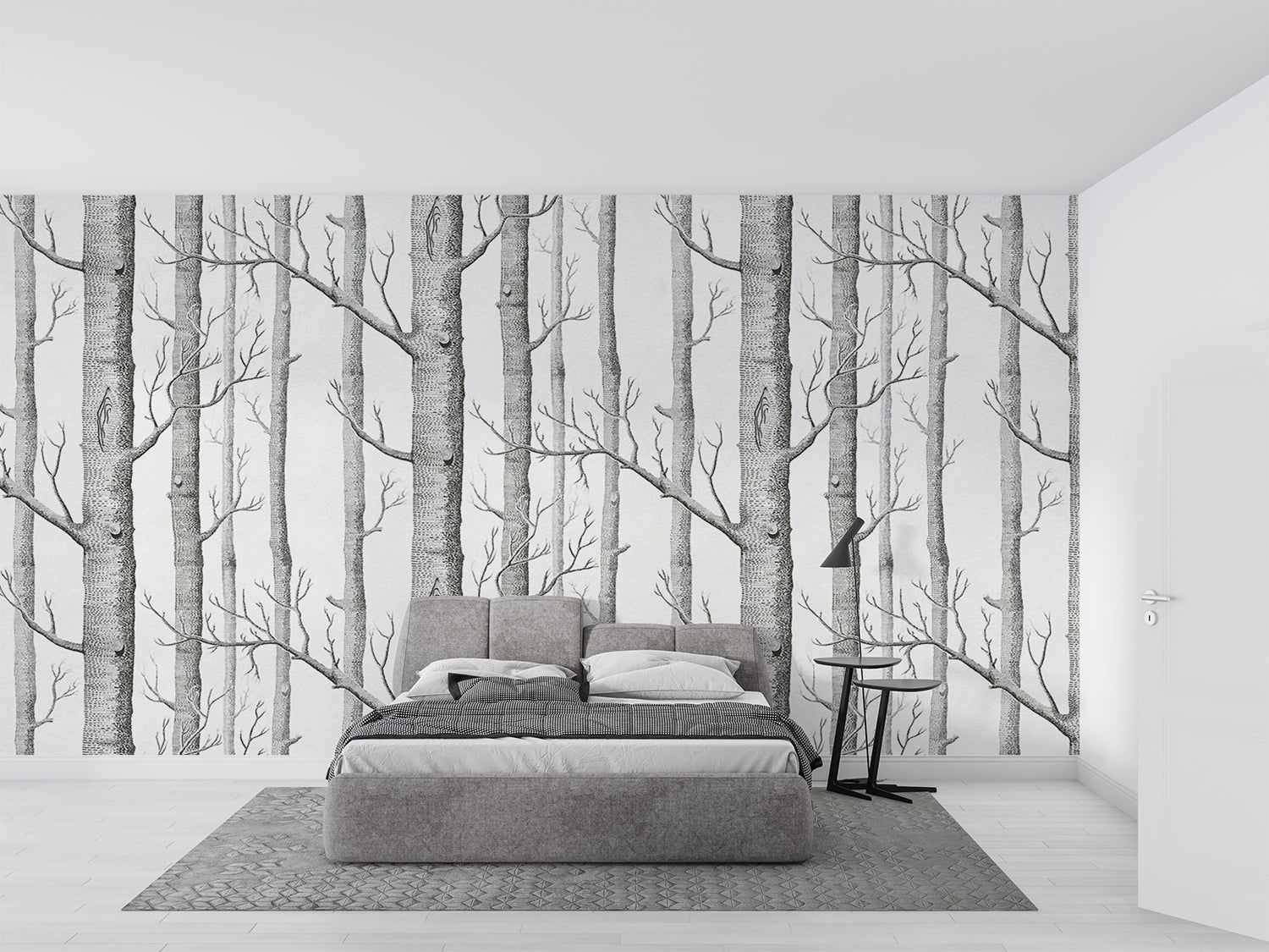 Black and white forest wallpaper creating depth in modern living room with minimal furniture
