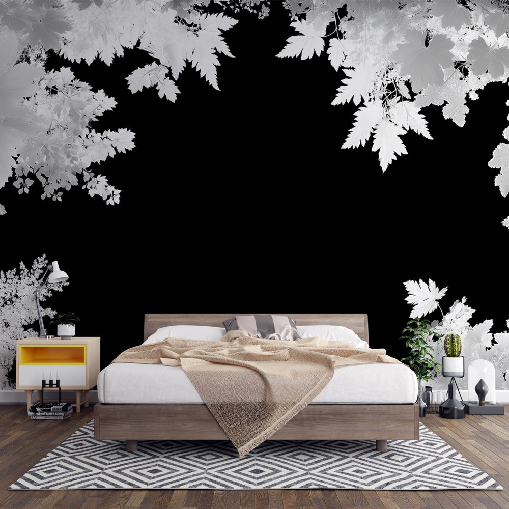 Black and white forest wallpaper creating dramatic contrast in a modern living room with minimalist furniture