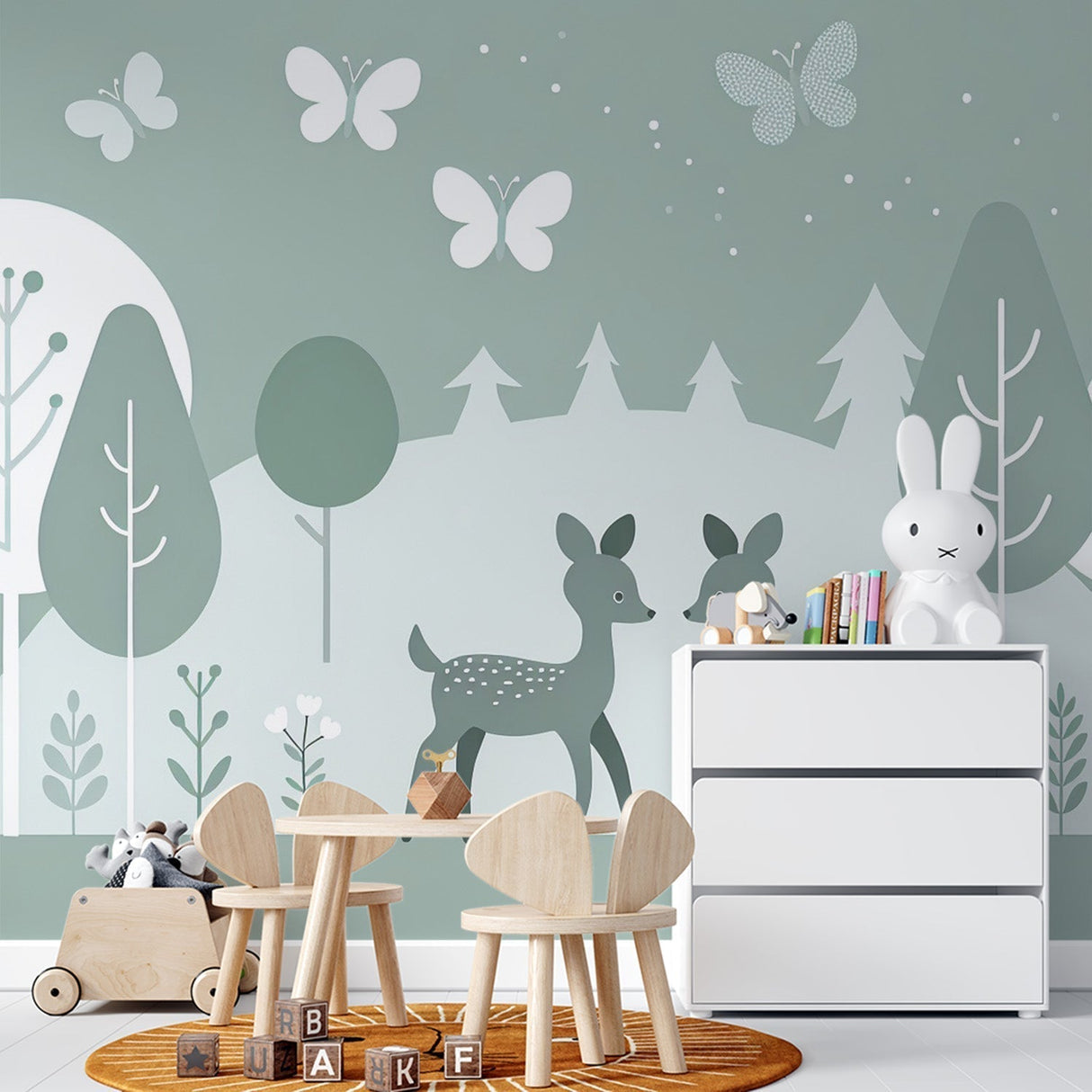 Forest animals wallpaper with deer and butterflies creates a magical atmosphere in a bright, airy nursery