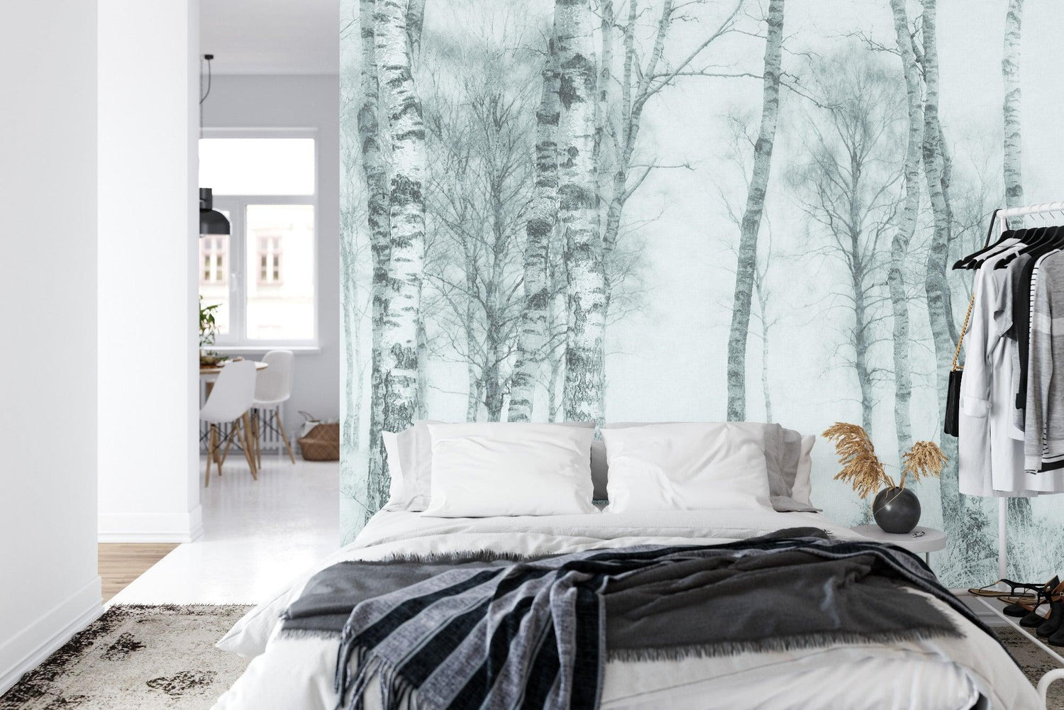 Monochrome birch tree mural adding character to bedroom wall behind bed