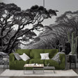 Monochrome forest wallpaper creating depth in a modern living room with high ceilings and minimal furniture