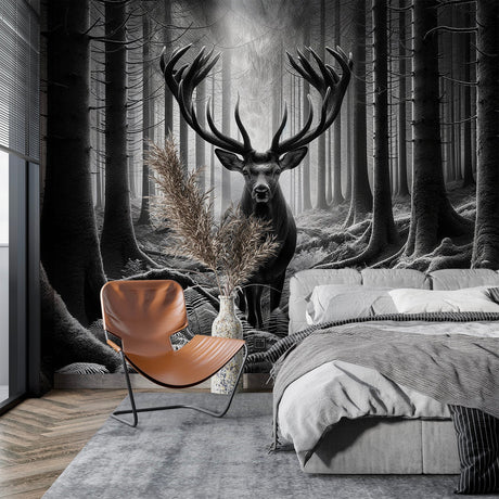 Black and white forest mural wallpaper with deer shown in modern minimalist living room with grey sofa and natural light