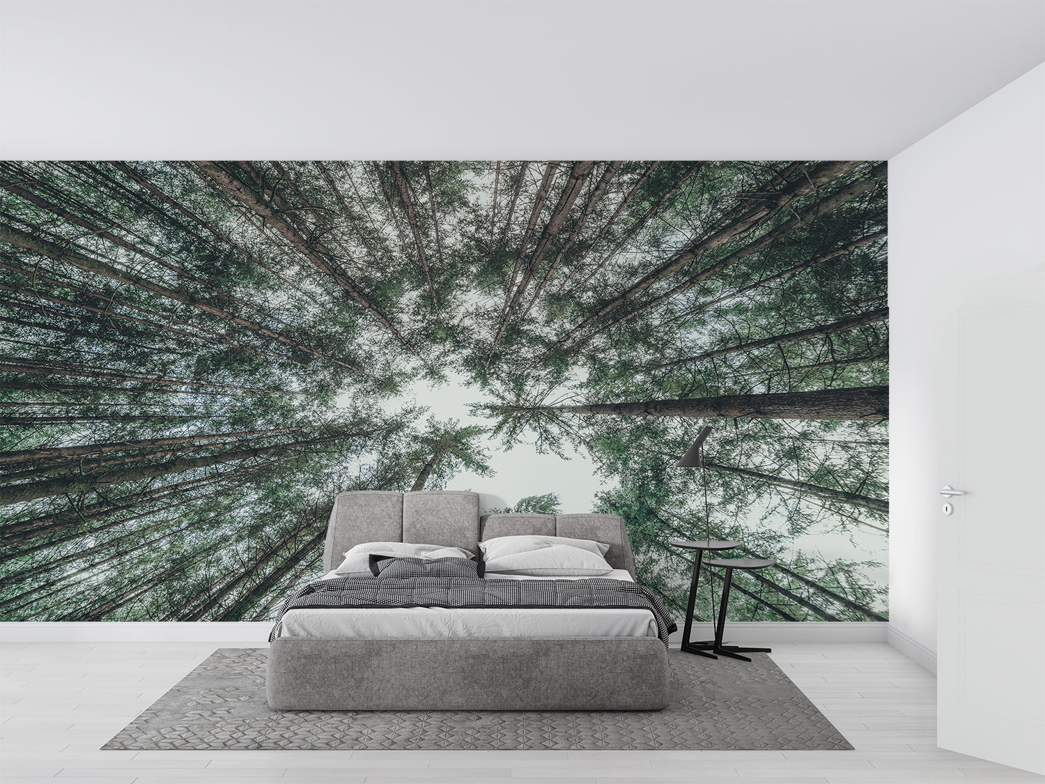 Forest canopy wallpaper creating depth in a modern living room with high ceilings