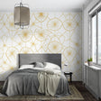 Geometric gold sunburst wallpaper in modern living room with white sofa and natural light