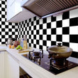 Black and white geometric wallpaper in modern kitchen showing clean lines and bold pattern
