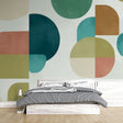 Modern geometric circle wallpaper creating a stylish backdrop in a minimalist living room with natural light