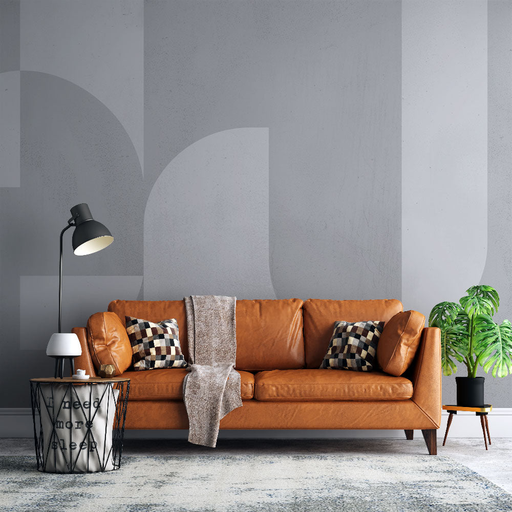 Modern geometric circle wallpaper creating depth in a minimalist living room with grey and white furniture