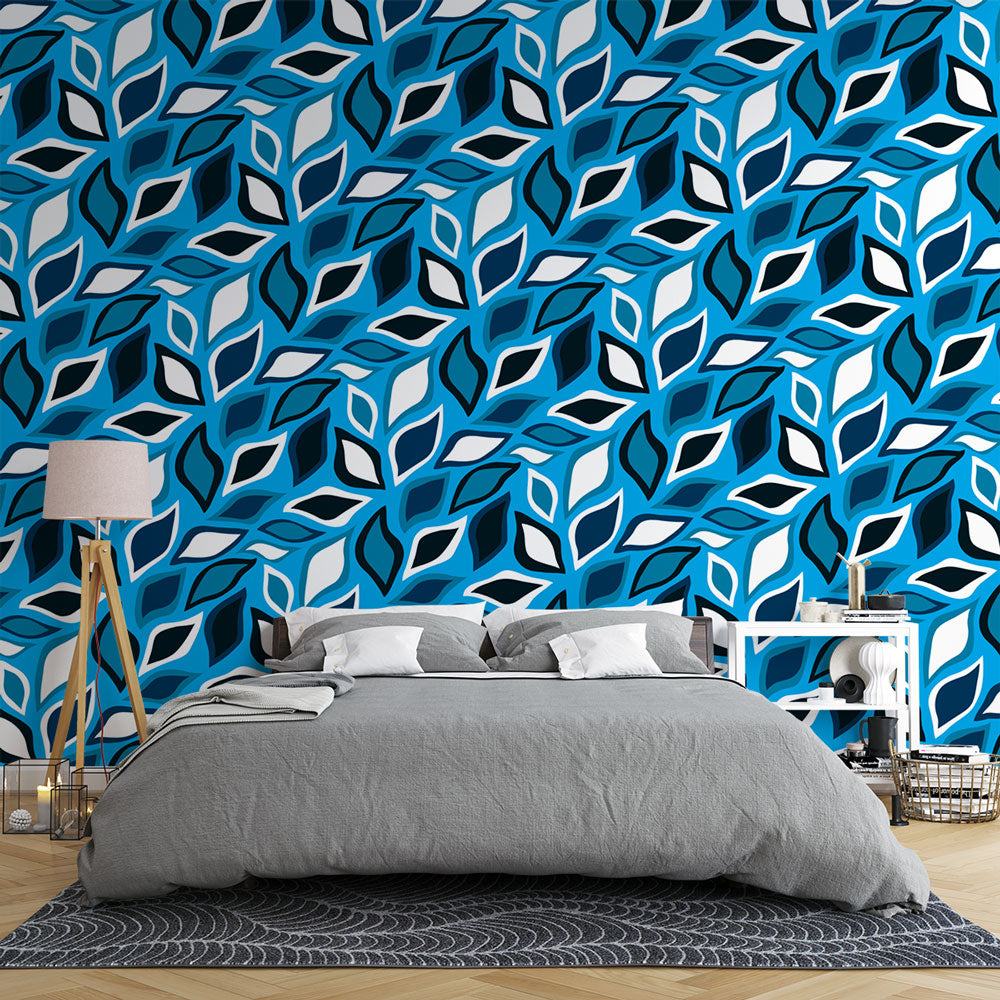Modern geometric leaf wallpaper in blue and white creating a fresh look in a bright living room with minimal furniture