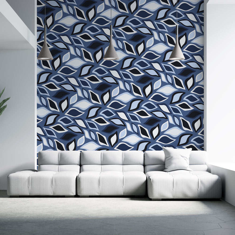 Modern geometric leaf wallpaper in blue tones creating a striking accent wall in a minimalist living room setting