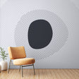Modern geometric wallpaper creating depth in a minimalist living room with natural light and clean furniture arrangement