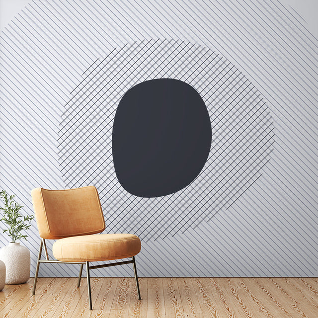 Modern geometric wallpaper creating depth in a minimalist living room with natural light and clean furniture arrangement