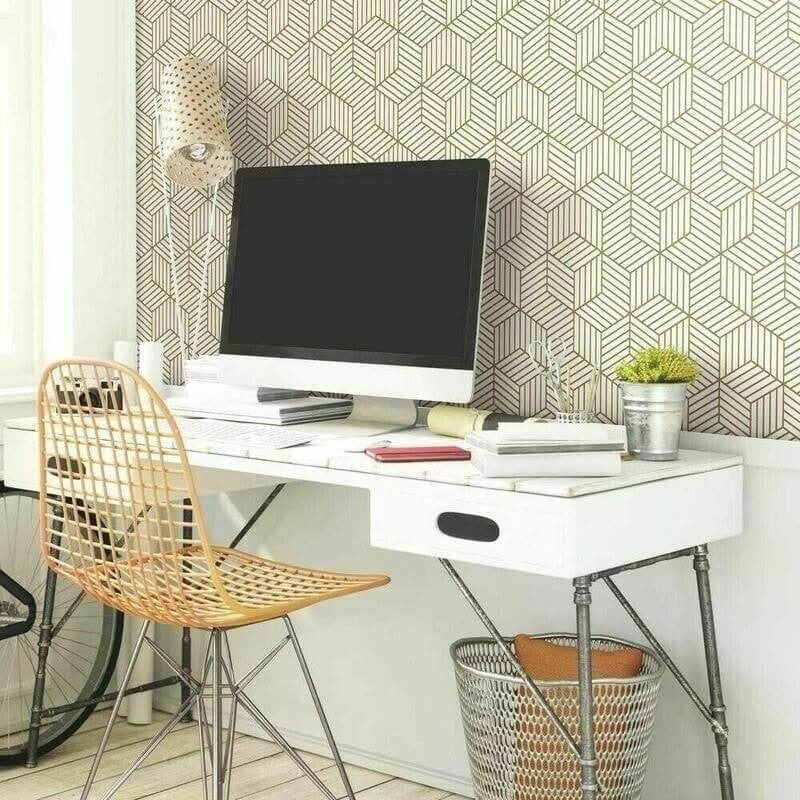 Geometric pattern wallpaper creating depth in a modern home office space