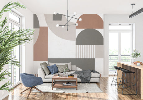 Modern geometric wallpaper in bright living room with grey sofa and natural light