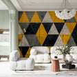 Modern geometric triangle wallpaper in yellow and black creating a bold statement in a minimalist living room