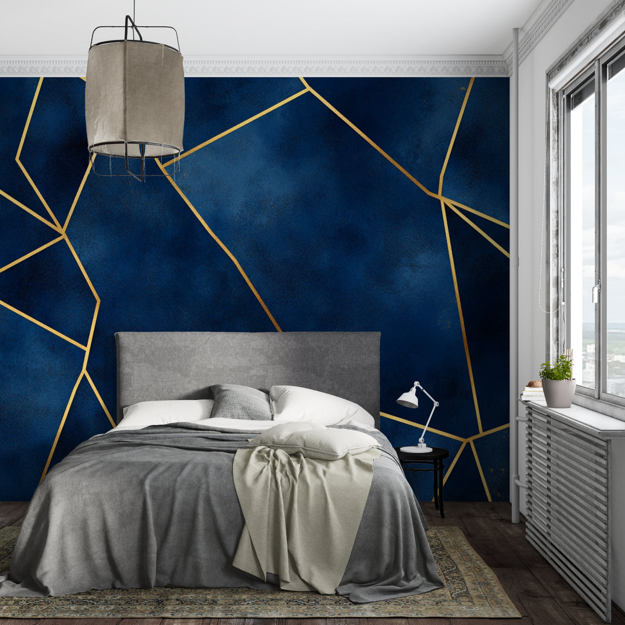Modern geometric wallpaper featuring navy and gold lines in dining room with pendant lighting