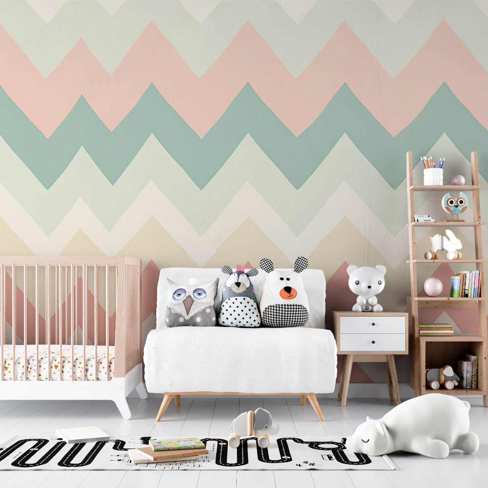Geometric chevron wallpaper in soft pink and sage creating a peaceful nursery atmosphere with natural light