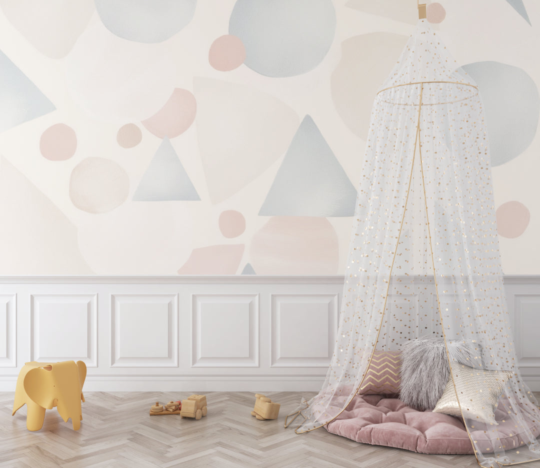 Geometric nursery wallpaper with pastel shapes in a bright, modern nursery setting with white furniture