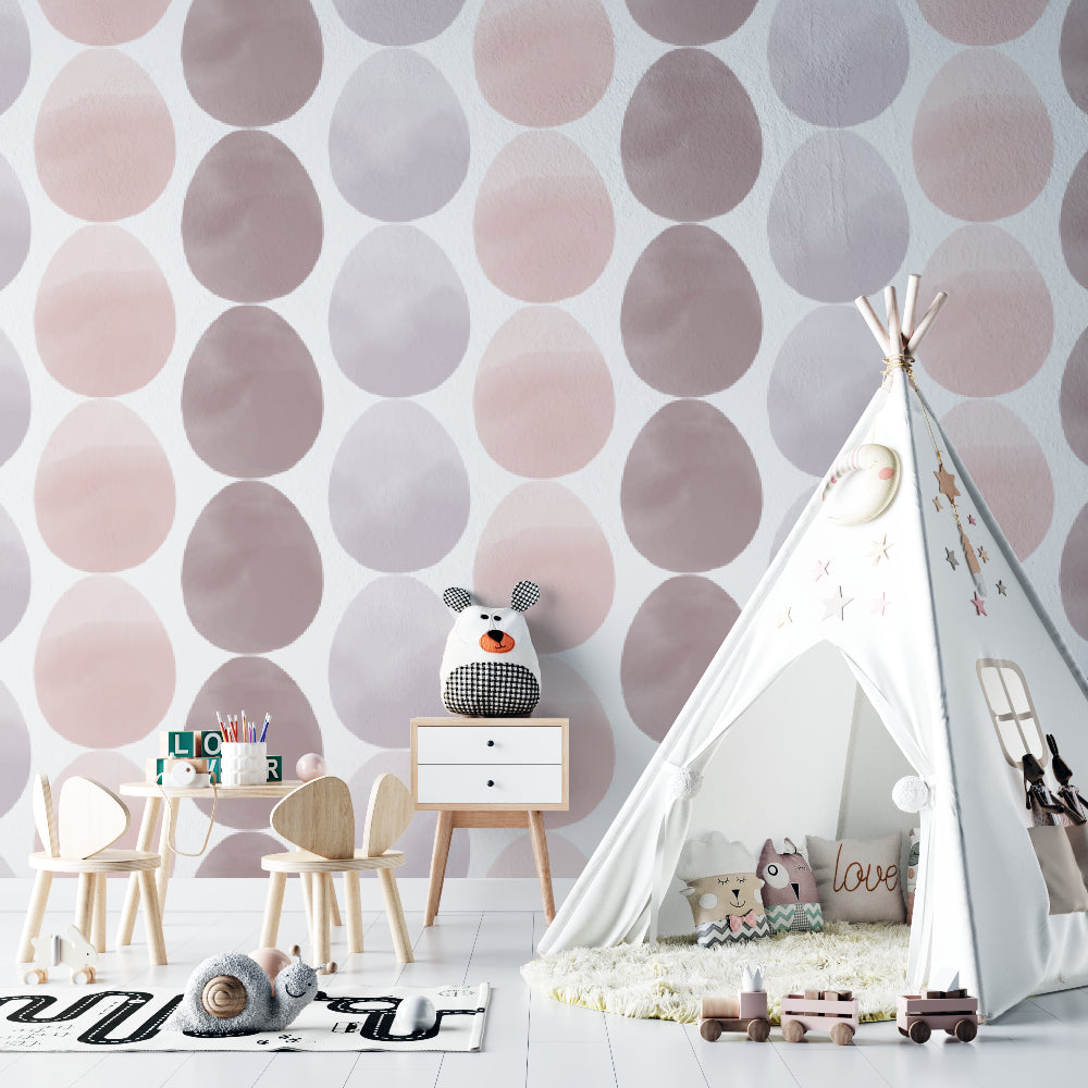 Pink and grey geometric circle wallpaper in modern nursery with white furniture and soft textiles