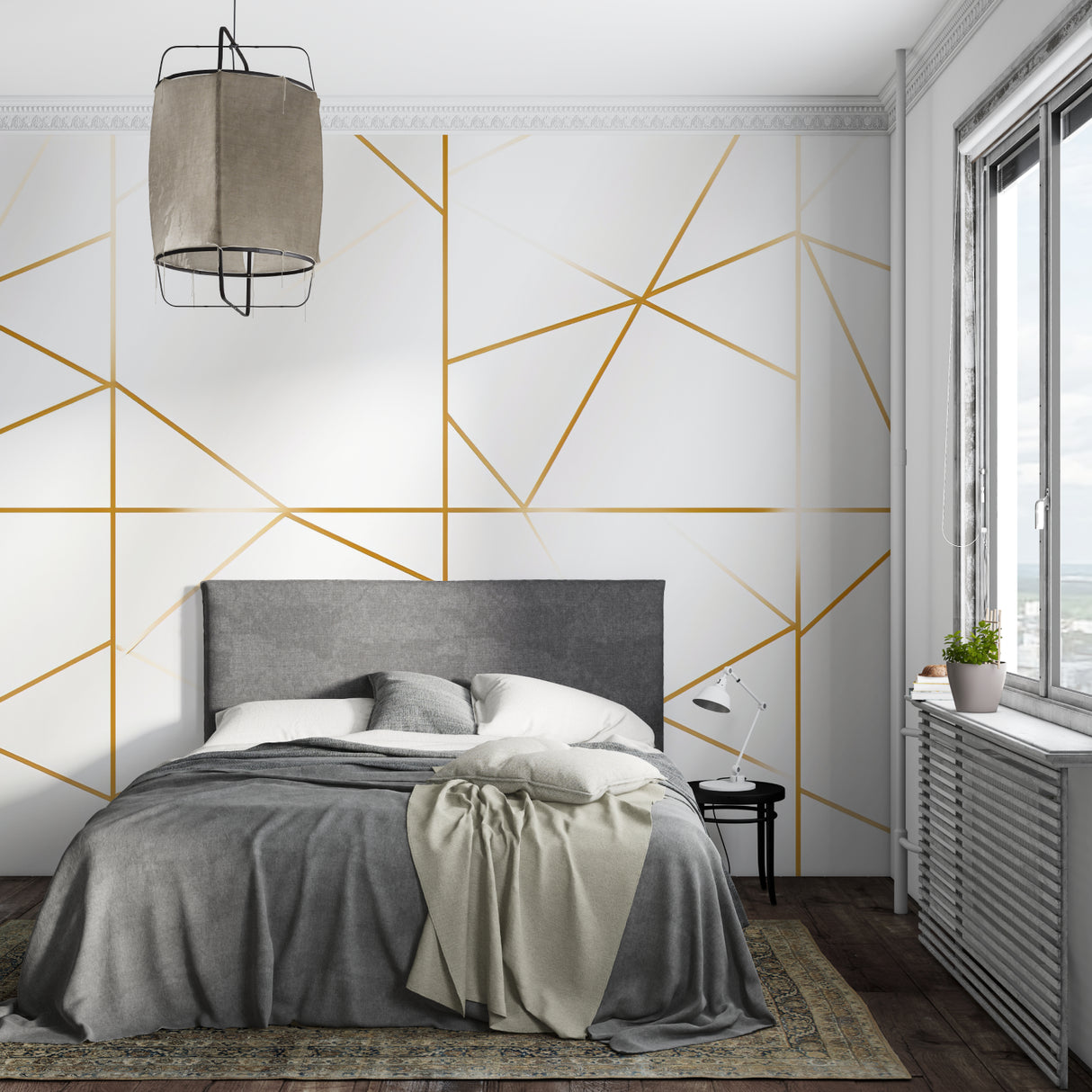 Modern geometric white and gold wallpaper in a bright living room with natural light highlighting the metallic lines