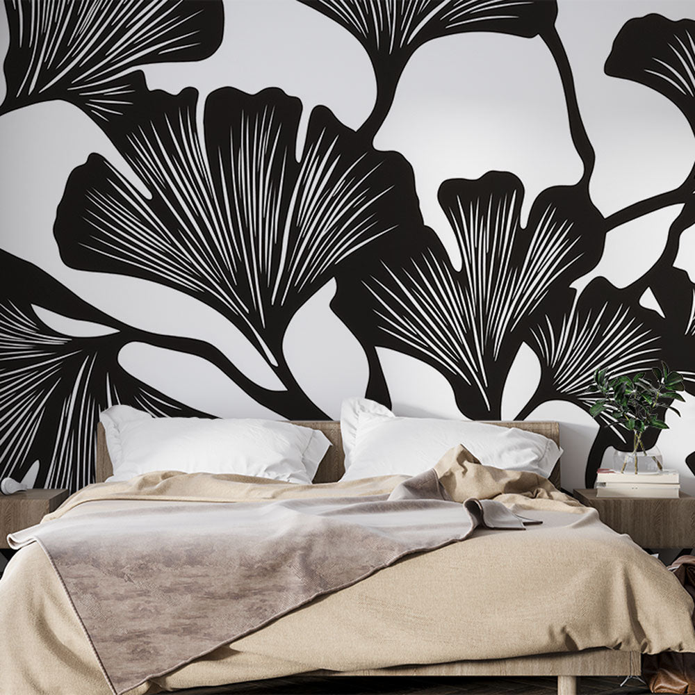 Black and white Ginkgo botanical wallpaper creating a stunning accent wall in a modern minimalist living room setting