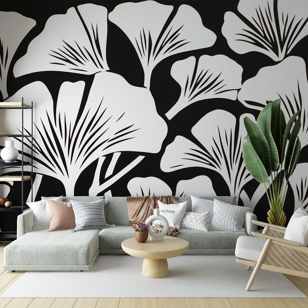 Black and white Ginkgo leaf wallpaper creating dramatic contrast in a modern living room with minimal furniture