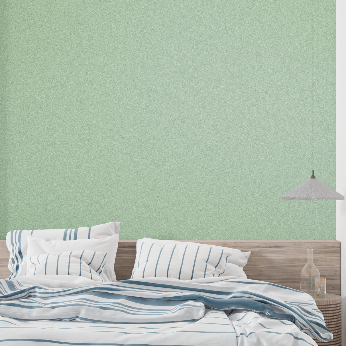 Sage green minimalist wallpaper in modern living room showing textured surface catching natural light