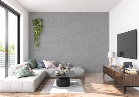 Modern grey textured wallpaper in a bright living room setting with minimal furniture