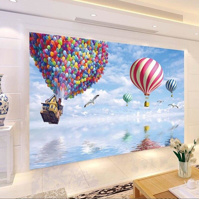 Reading nook with whimsical hot air balloon wall mural showing house lifted by balloons
