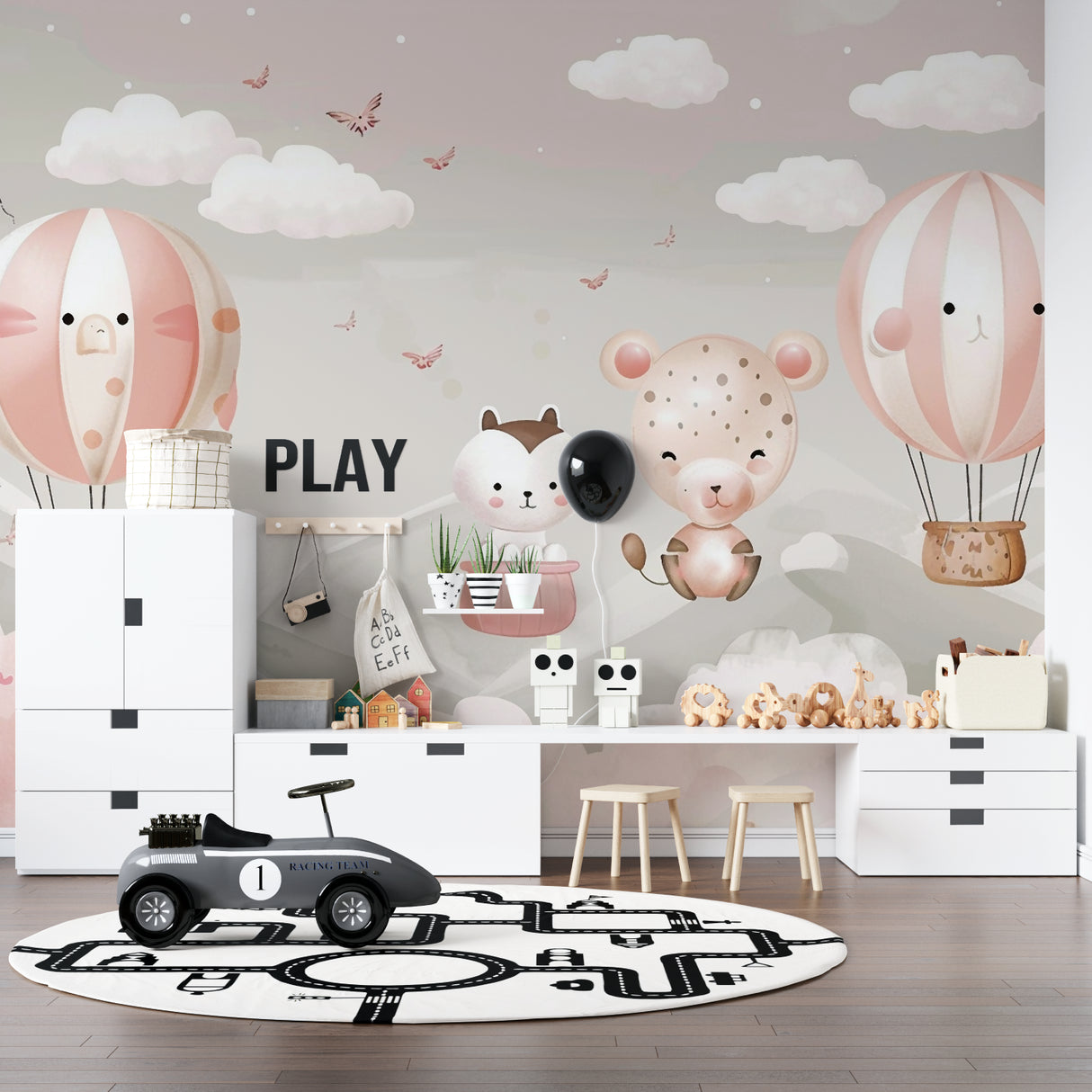 Pink hot air balloon mural creating a cozy reading nook in a kids bedroom