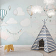 Hot air balloon wallpaper brings whimsy to a bright nursery, with soft pastel colors creating a dreamy atmosphere