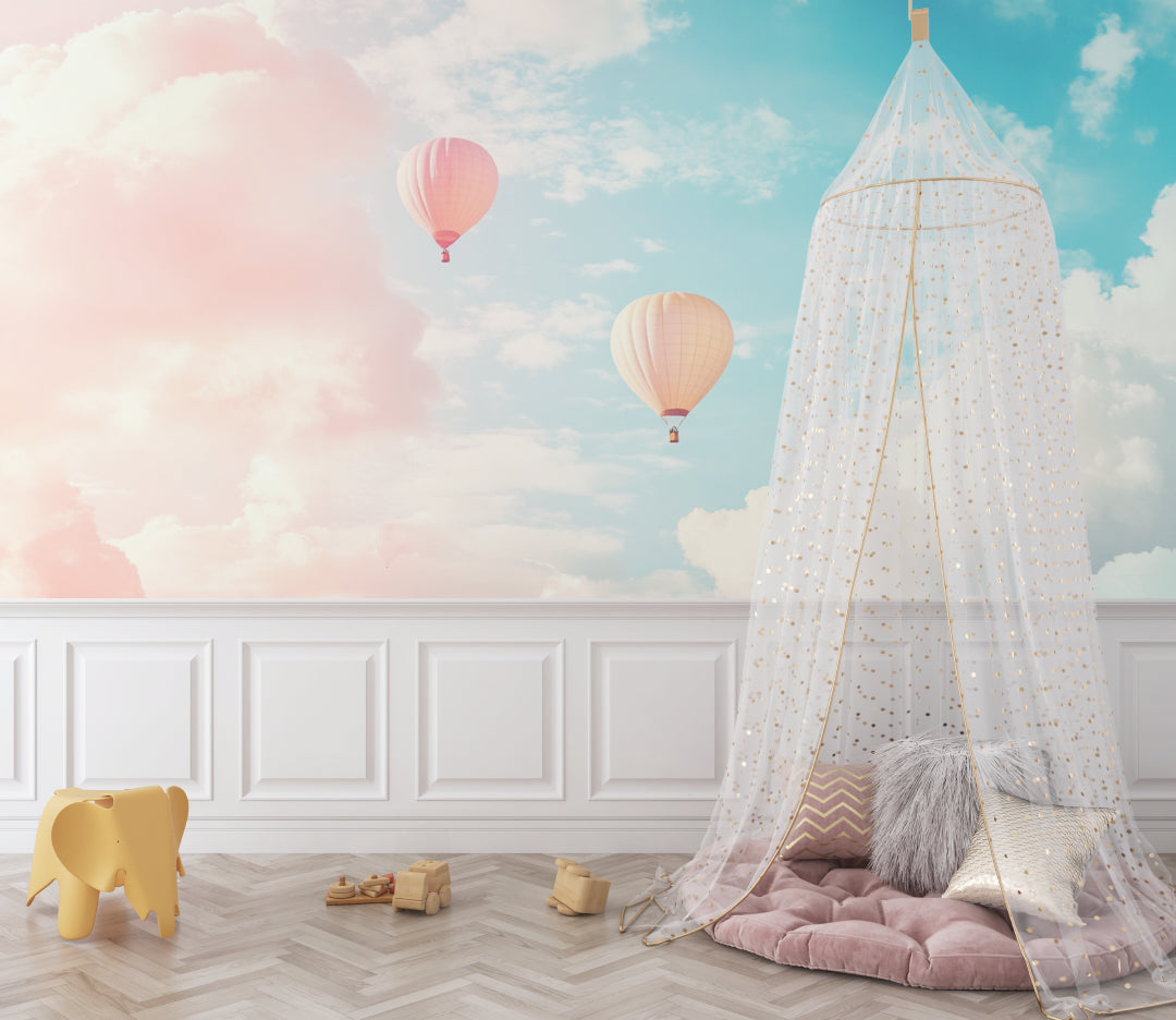 Baby room with soft pink hot air balloon wall mural and matching decor