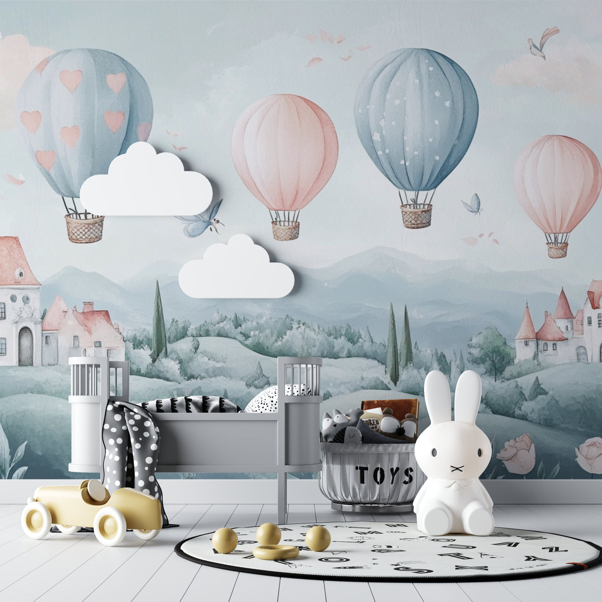 Fantasy balloon wallpaper transforming a children's bedroom with pastel decor and white furniture