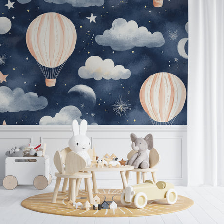 Hot air balloon wallpaper in a cozy nursery with soft lighting showing pink balloons against starry night sky