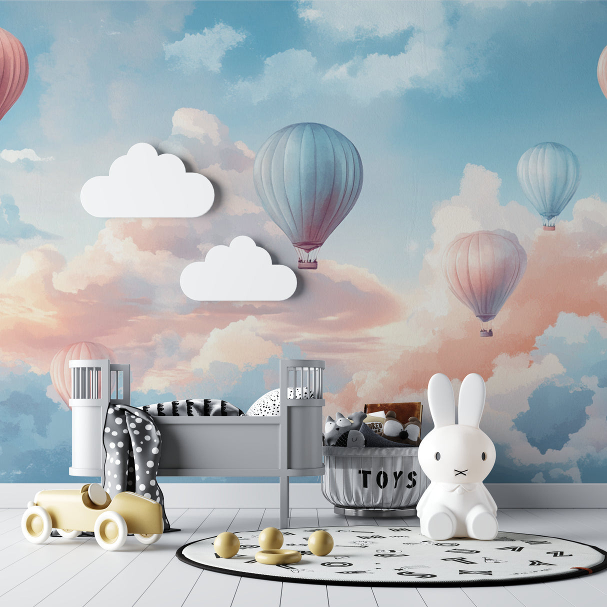 Hot air balloon nursery wallpaper in a bright modern nursery with white furniture