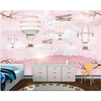 Hot air balloon wallpaper creating a magical atmosphere in a bright nursery with pink accents and white furniture