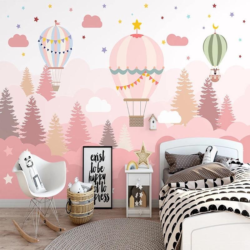 Hot air balloon wallpaper in a modern nursery, creating a dreamy pink atmosphere with floating balloons and stars