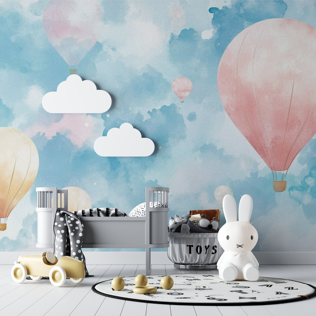 Watercolor balloon mural adding whimsy to a girl's bedroom with pink accents