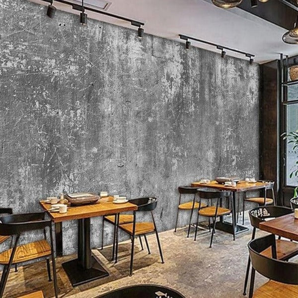Concrete wall mural creating industrial atmosphere in urban style restaurant with exposed lighting