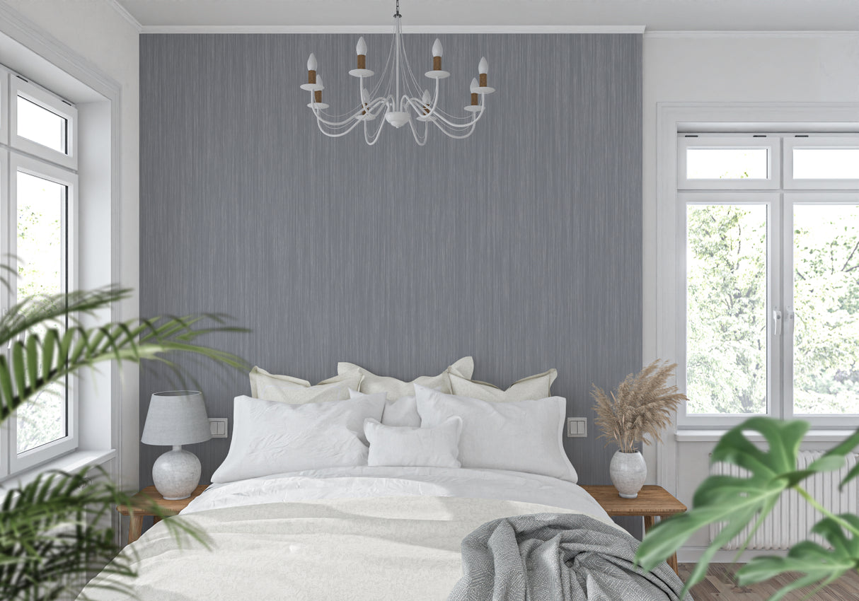 Metallic grey wallpaper in urban loft bedroom showing light reflection