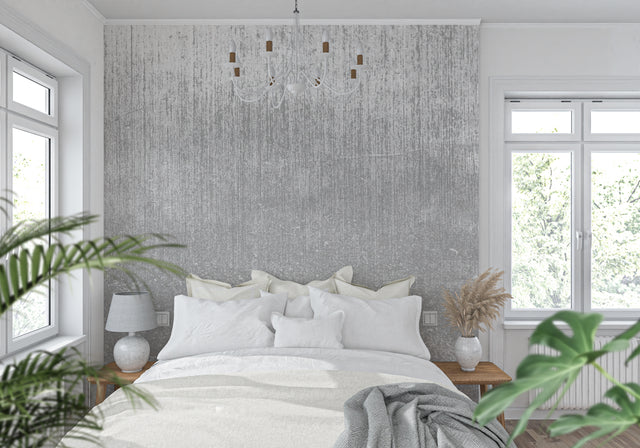 Modern grey industrial wallpaper in a minimalist living room with natural light highlighting the metallic texture