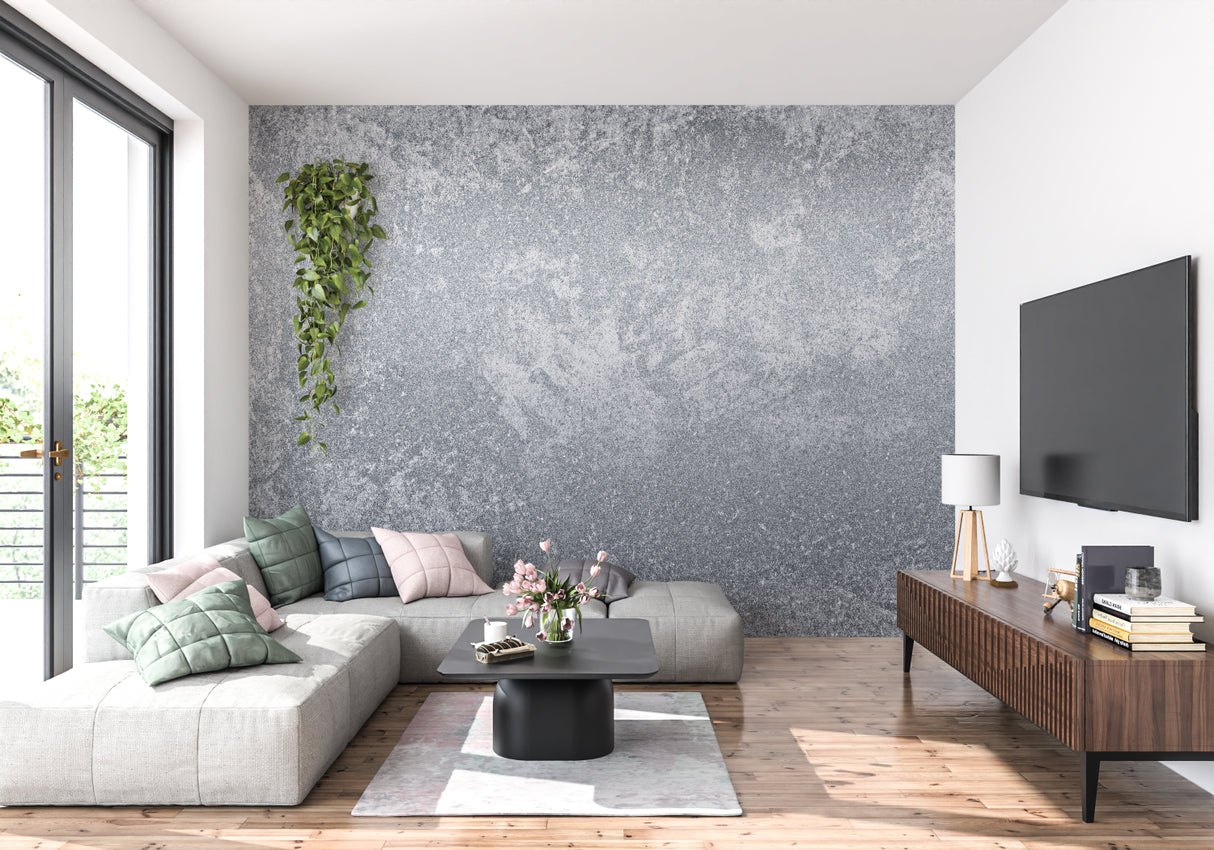 Modern grey concrete wallpaper in a minimalist living room with leather sofa and metal accents