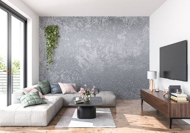 Modern grey concrete wallpaper in a minimalist living room with leather sofa and metal accents