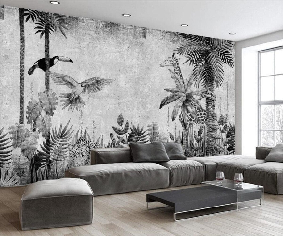 Black and white jungle mural wallpaper styled in modern living room with clean furniture and natural light